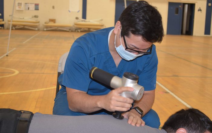 A photo of a patient receiving treatment at the SCU Health Tent Event