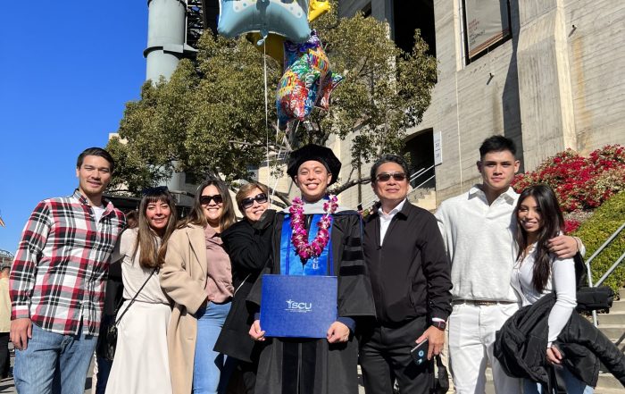 A photo of Jonathan Anthony Enriquez Carlos with his family at the Class of 2021 commencement ceremony.