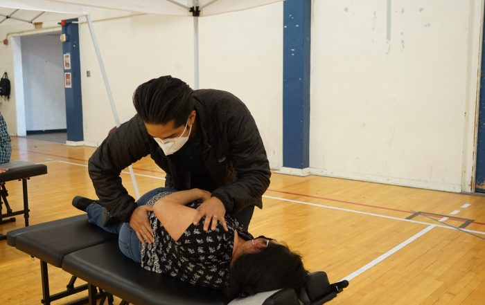 An action photo of a chiropractic adjustment being made on a patient