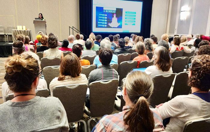 Photo of SYTAR 2023 attendees watching presentation